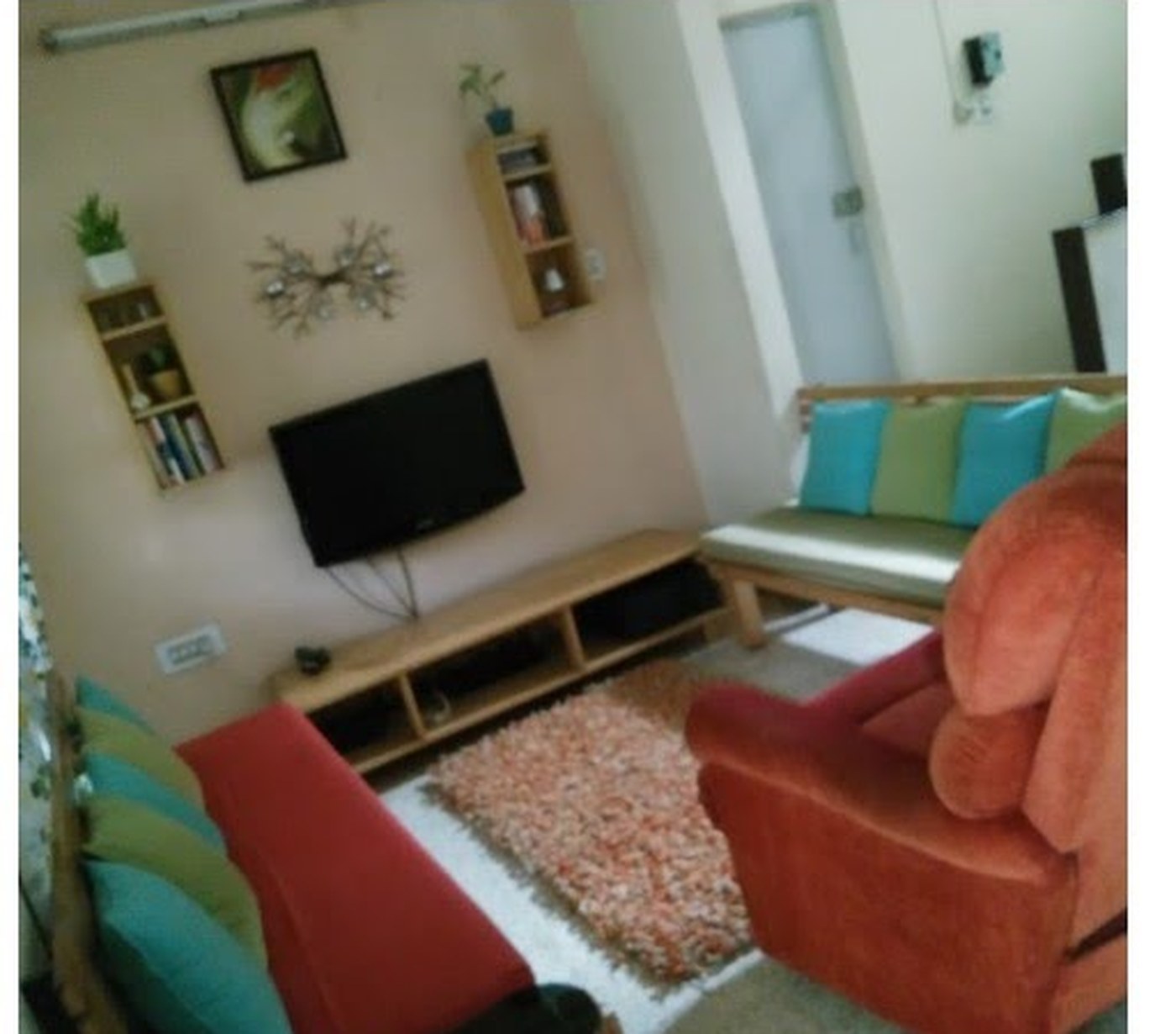The original living room with the console in place, cushions and shelving around it