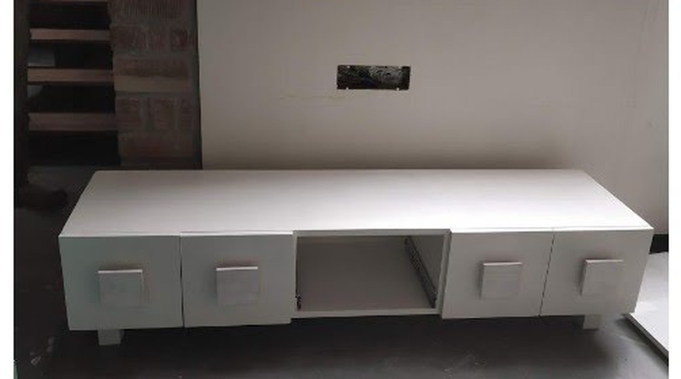 The console primed in white, standing in the new house before its final colour